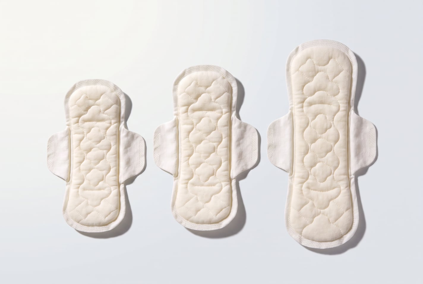 Render of three winged pads laid side by side on a pale ground, rising in length from left to right