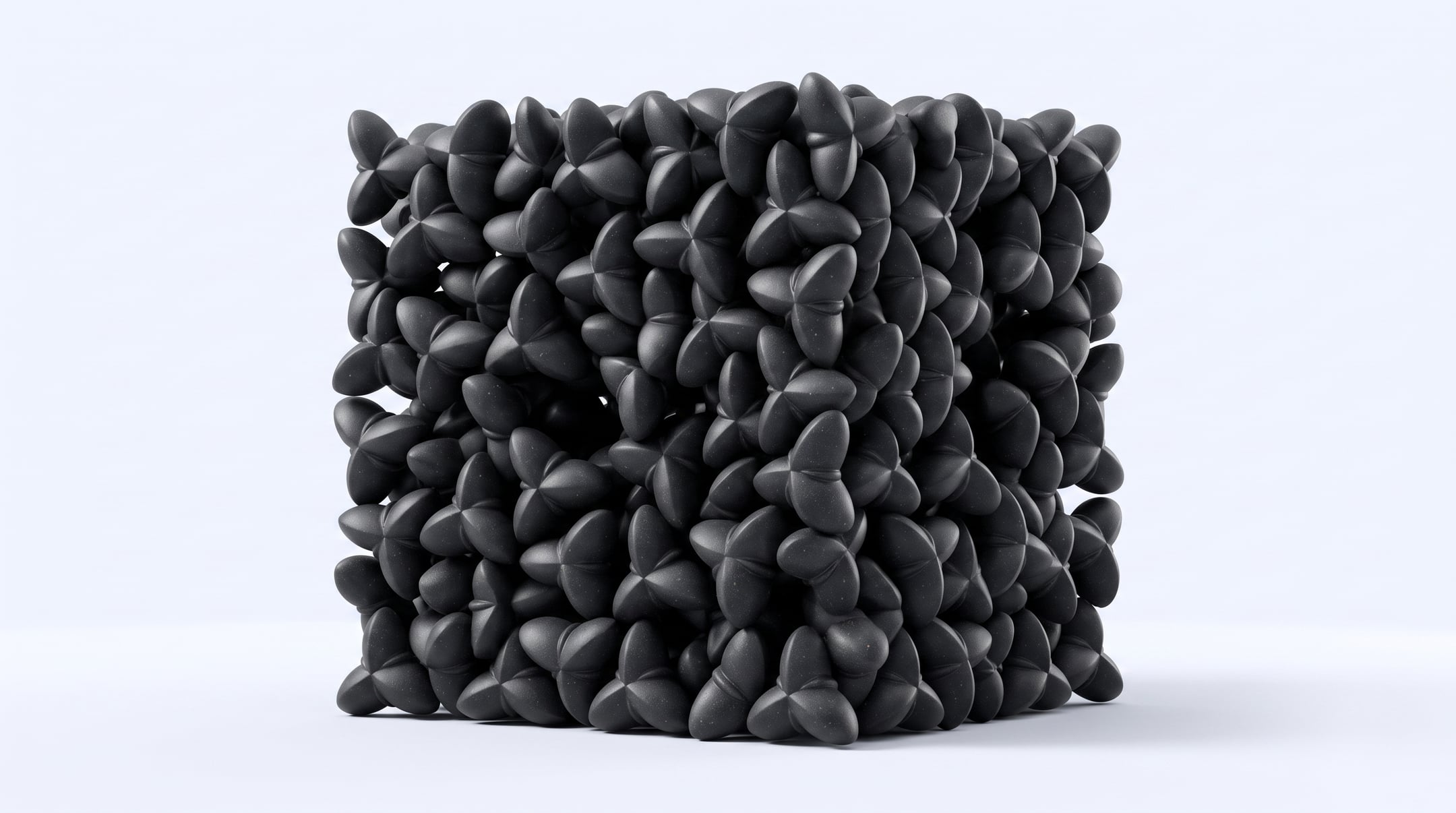 Render of a cube of black Oberon modules packed at random, their fins holding neighbours apart with gaps between them