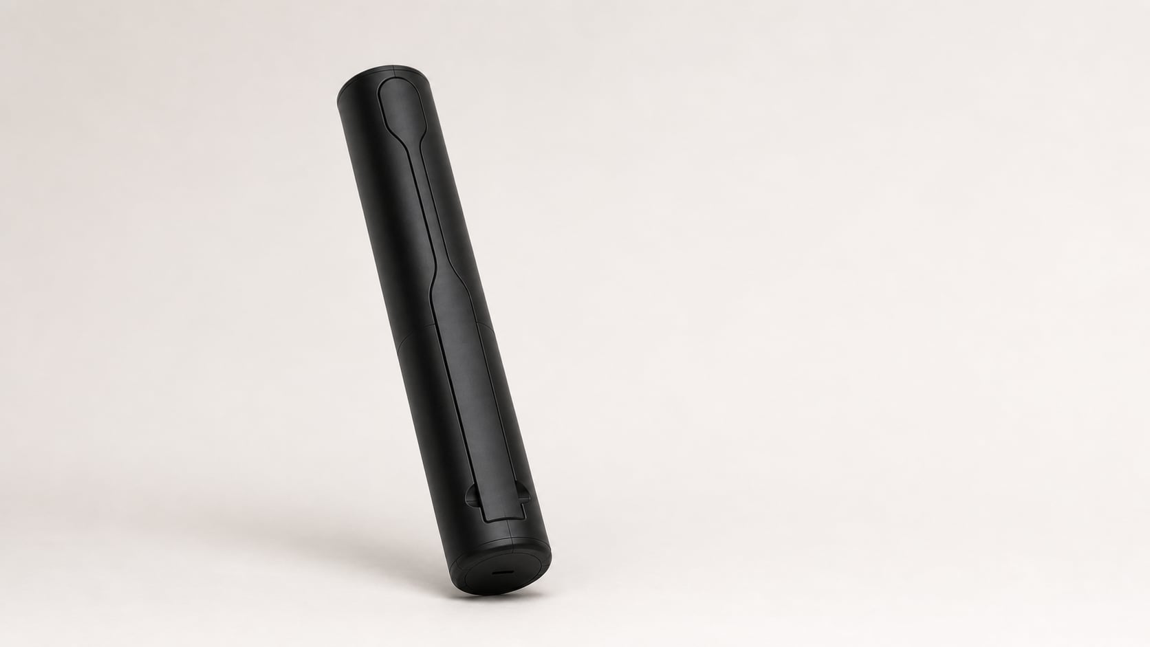 Render of the closed Oracell case standing on its base cap: a plain black cylinder with a single seam and the USB-C port at the foot